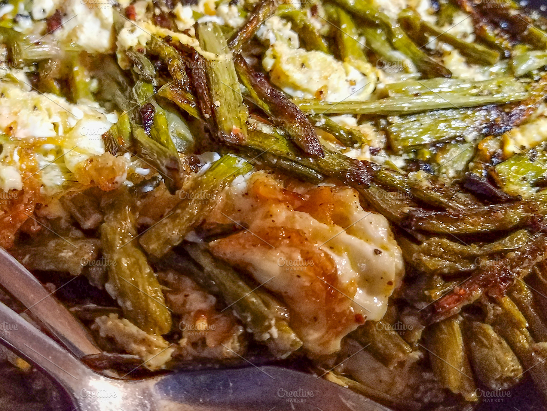 Grilled green beans with melted cheese in black bowl, a Food & Drink Photo by DanFLCreativo