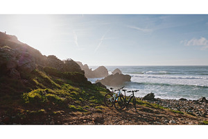 Bicycles standing on coastal path, a Nature Photo by Goinyk