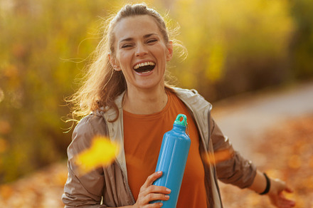 smiling modern woman in fitness clothes in park, a Sports & Recreation Photo by Alliance Images