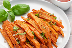 Sweet potato fries on white plate with sauces, a Food & Drink Photo by Olena Rudo