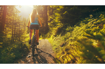 Woman Riding Bike on Dirt Road, a Transportation Photo by CREATIVEDEF