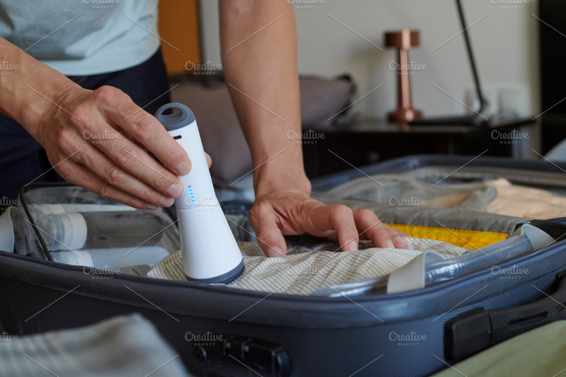 packing a suitcase with vacuum storage bags, a Photo by Nito