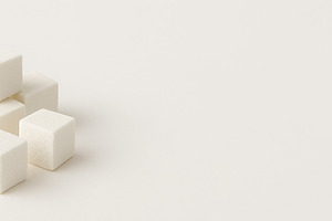 Sugar cubes neatly stacked on a light background with copy space, a Photo by Dvoevnore photos