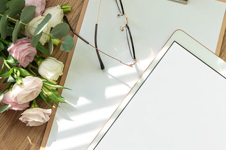 Stationery workspace with a blank tablet, notebook, and flowers, a School & Education Photo by Olena Rudo