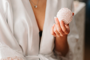 A young bride sits at a slot machine in the morning and drinks c