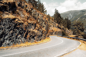 Curving mountain road view, a Transportation Photo by SkyNext