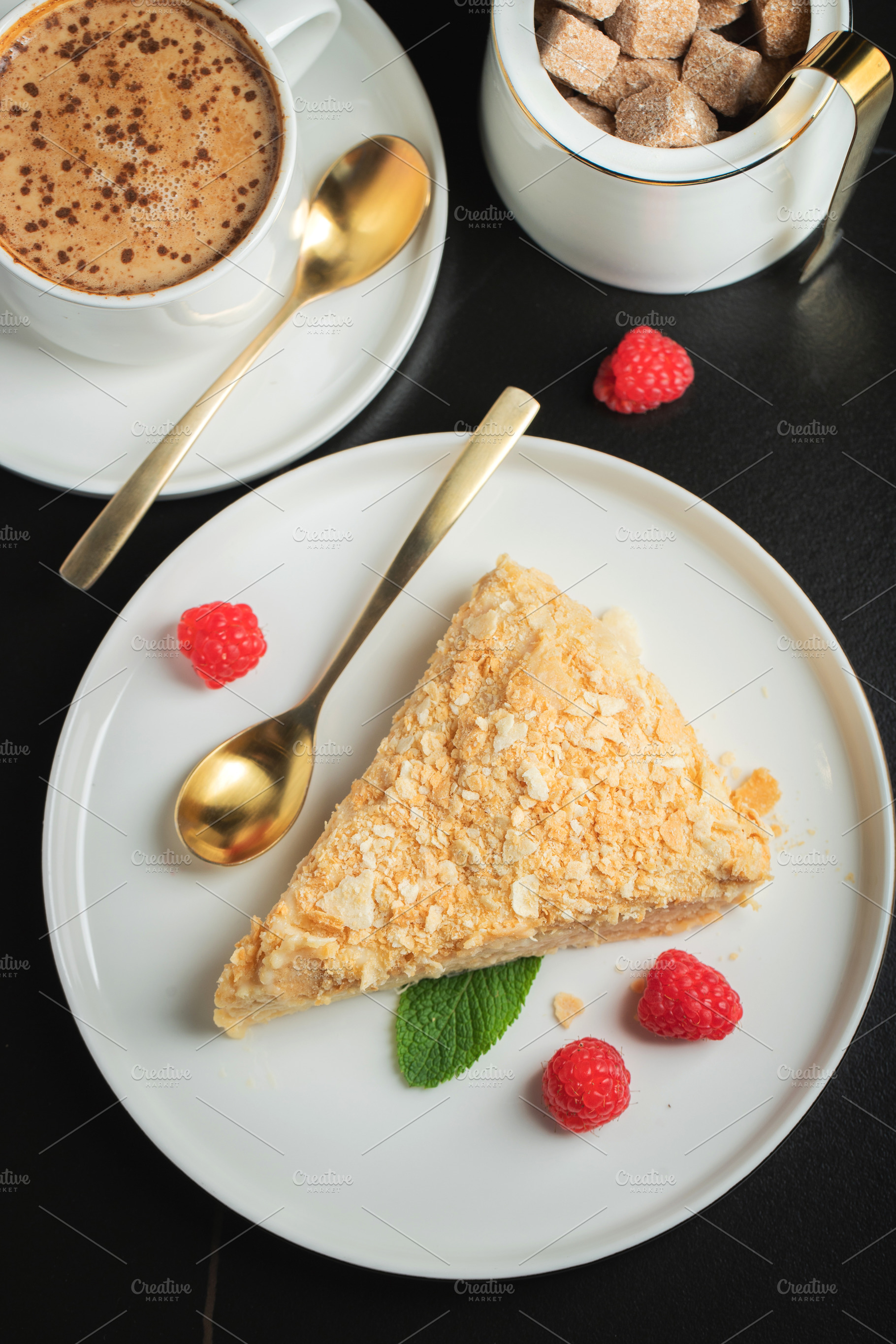 Sliced Napoleon cake on a white wooden table. Classic dessert, a Food & Drink Photo by Budarinphoto