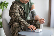 Cropped of military man checking blood pressure at home, a Photo by Prostock-Studio (Thumbnail 4 of 4)