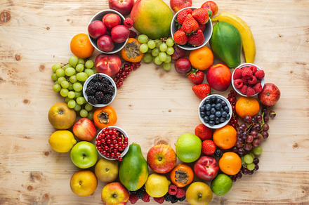 Rainbow fruits background containing fruits, rainbow, and top view