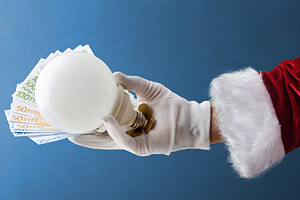 Concept of energy cost at Christmas with Santa's hand, a Business Photo by Davizro's Market