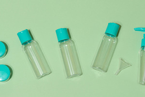 Top view of set of five transparent cosmetic bottles and two rou, a Health & Medical Photo by ndanko