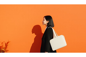 Asian businesswoman carrying a white, a Person Photo by Sergey Kotenev