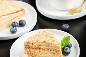 Medovik. Honey cake made from honey cakes with whipped sour crea, a Food & Drink Photo by Budarinphoto