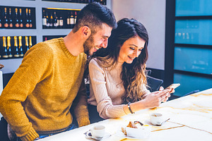 Young Couple Enjoying Coffee and Social Media, a Person Photo by Antonio Gravante Market