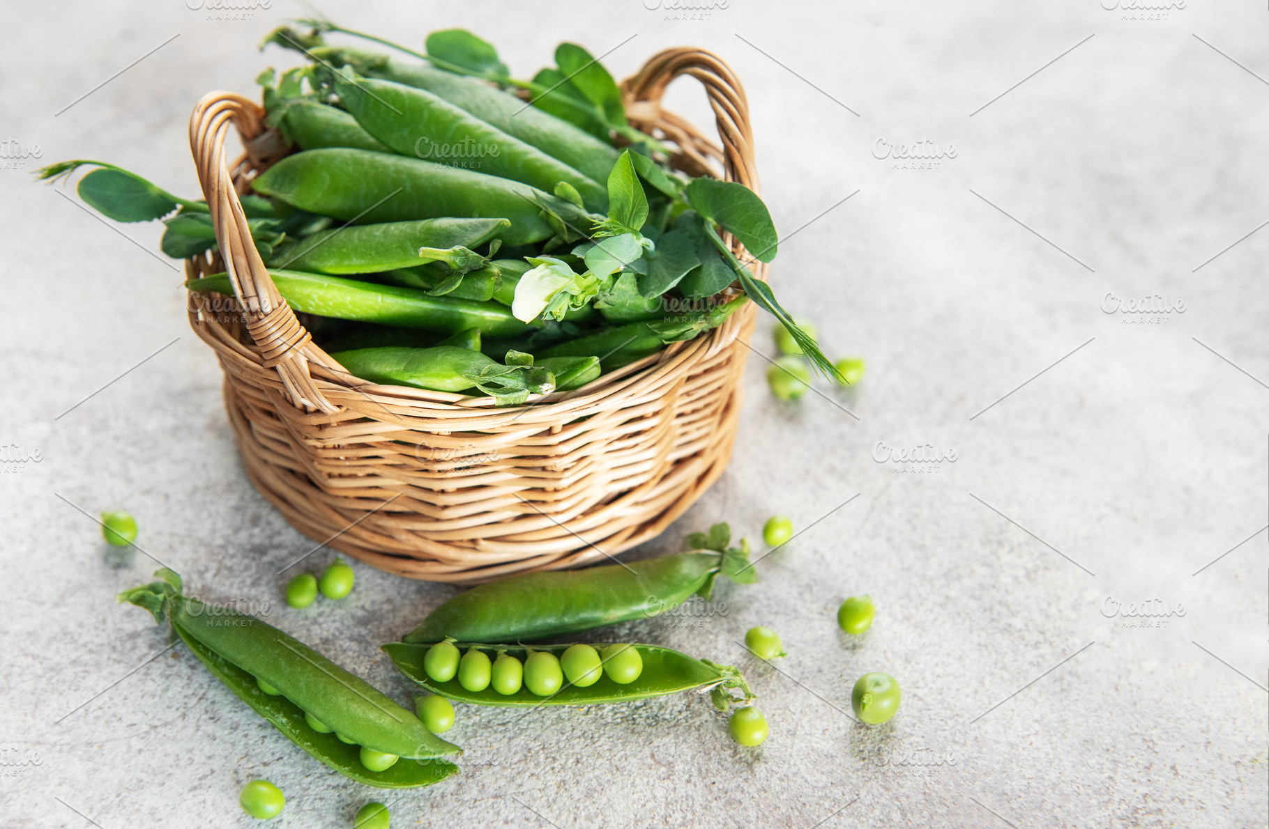 Fresh green peas pods in a wicker basket, a Food & Drink Photo by Olena Rudo