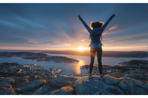 An adventurous man stands atop a, a Nature Photo by ZinetroN