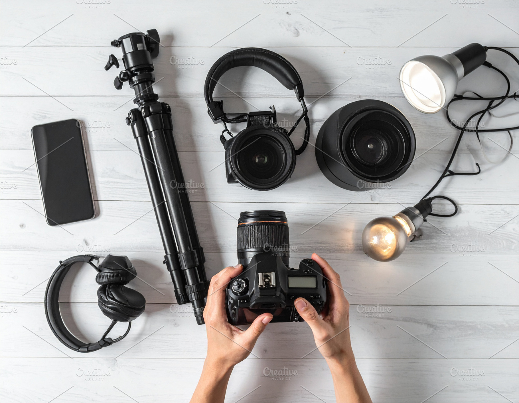 Wooden desk with hand handling with filming equipement, a Technology Photo by DanFLCreativo