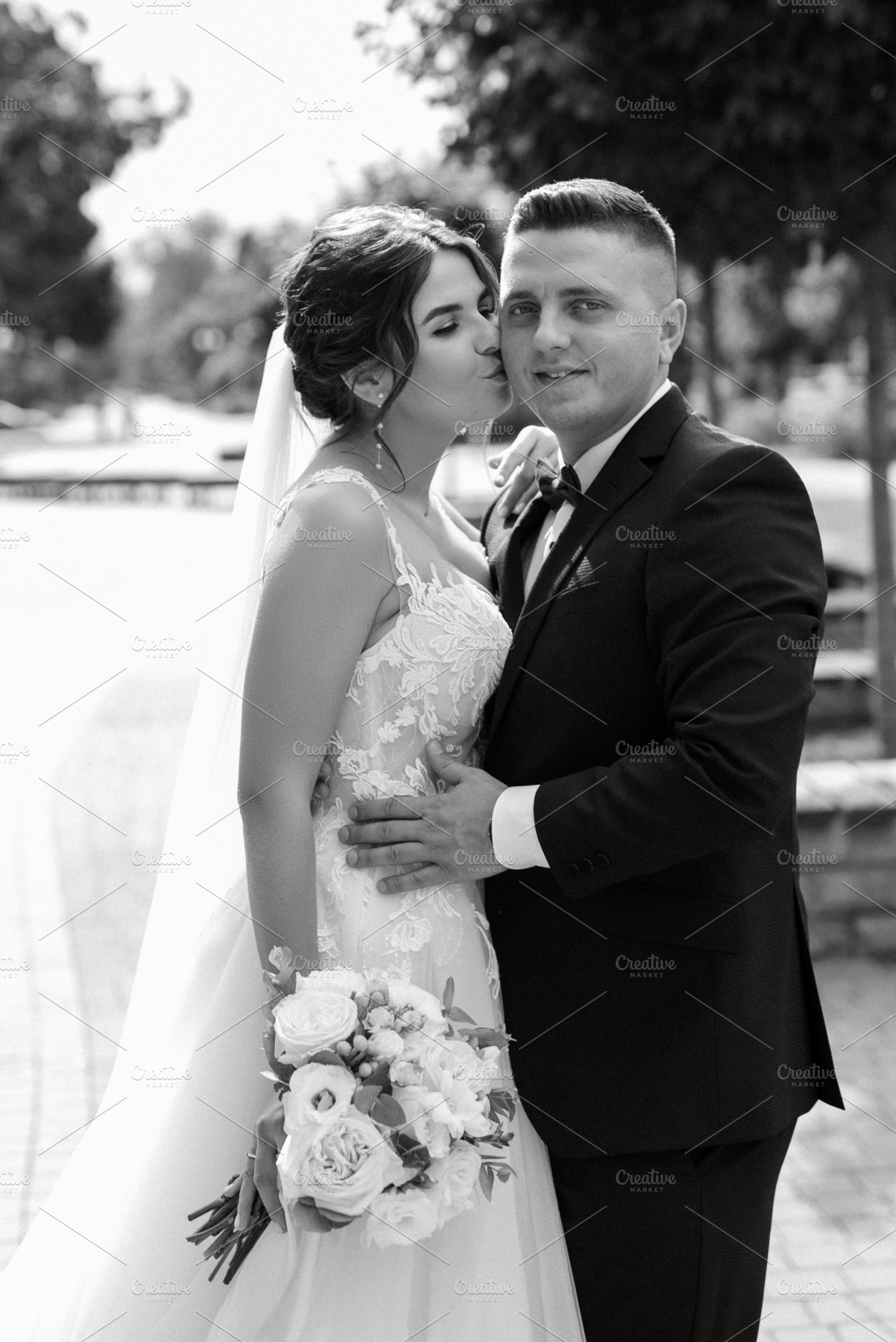 the groom in a brown suit and the bride in a white dress, a Person Photo by Weddings, People, Travel