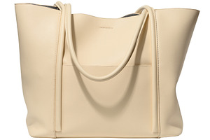 Beige leather women's bag with handles on isolated background, a Beauty & Fashion Photo by ndanko