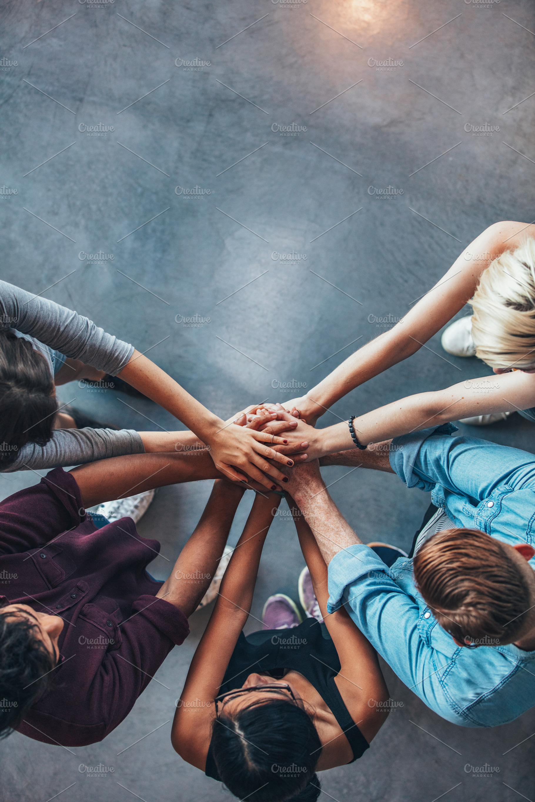 Stack of hands symbolizing trust containing above, achievement, and college, a School & Education Photo by Jacob Lund