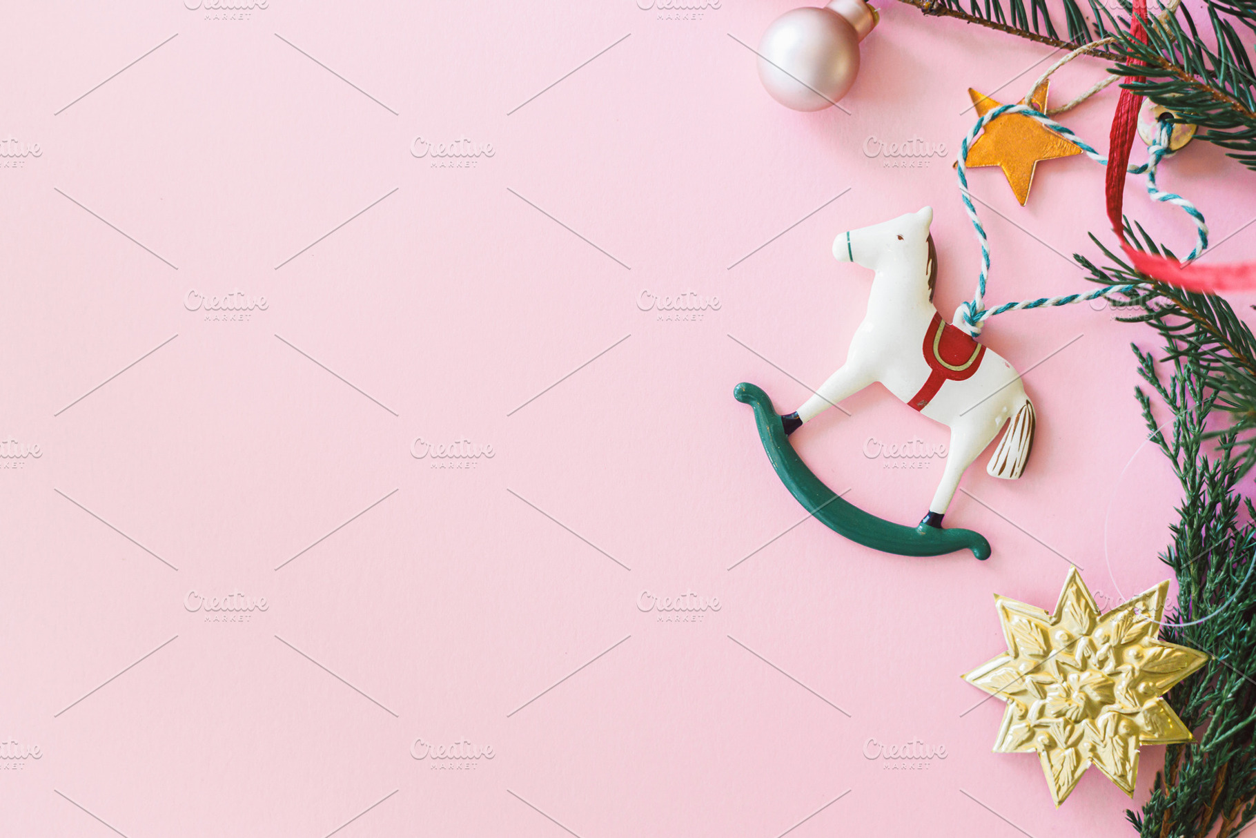 Horse christmas toy on pink flat lay with golden star, bauble an, a Holiday Photo by Sonjachni