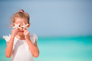 Adorable little girl with starfish on the beach featuring seastar, starfih