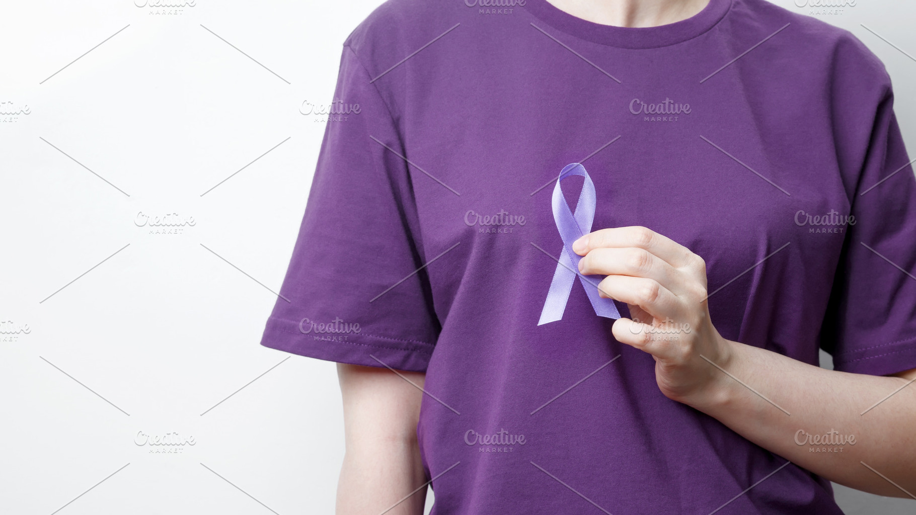 Purple ribbon held by a person in a purple shirt, symbol of support. Purple Epi, a Photo by matucha