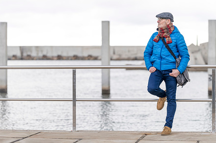 Relaxed mature man at the beach wearing casual clothes, a Person Photo by 2Design