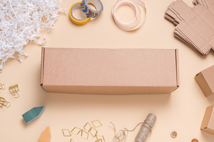 Cardboard box on color office desk, a Background Photo by MDBildes