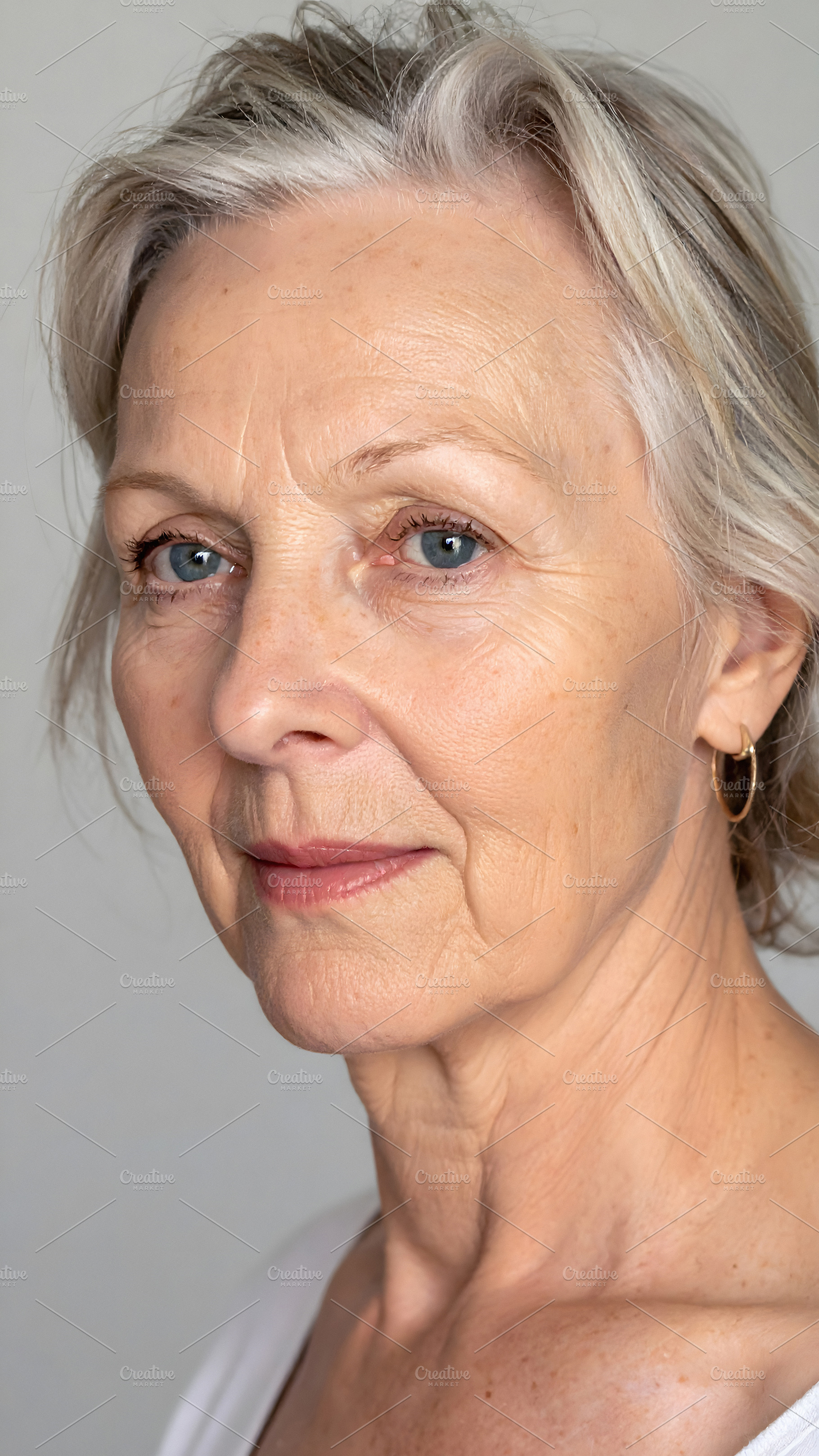 Senior woman with blue eyes and graceful aging expression, a Person Photo by GoodGoods