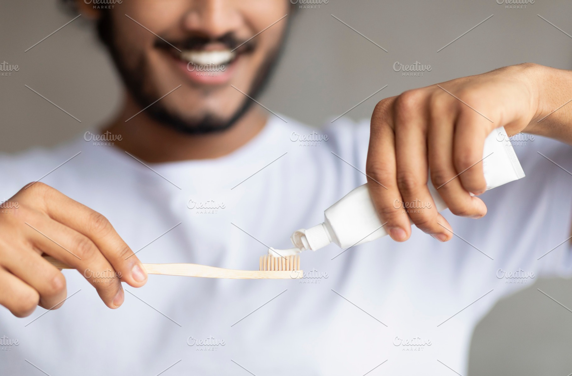 Morning time, personal oral hygiene and dental care. Young bearded man squeezin, a Person Photo by Prostock-Studio