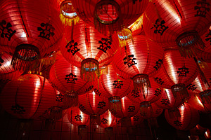 Red lanterns with decorative symbols glowing during a festive celebration, a Photo by AS photostudio