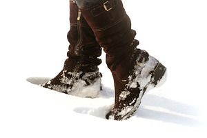 Brown women's shoes covered by snow in the winter featuring boot, snow, and