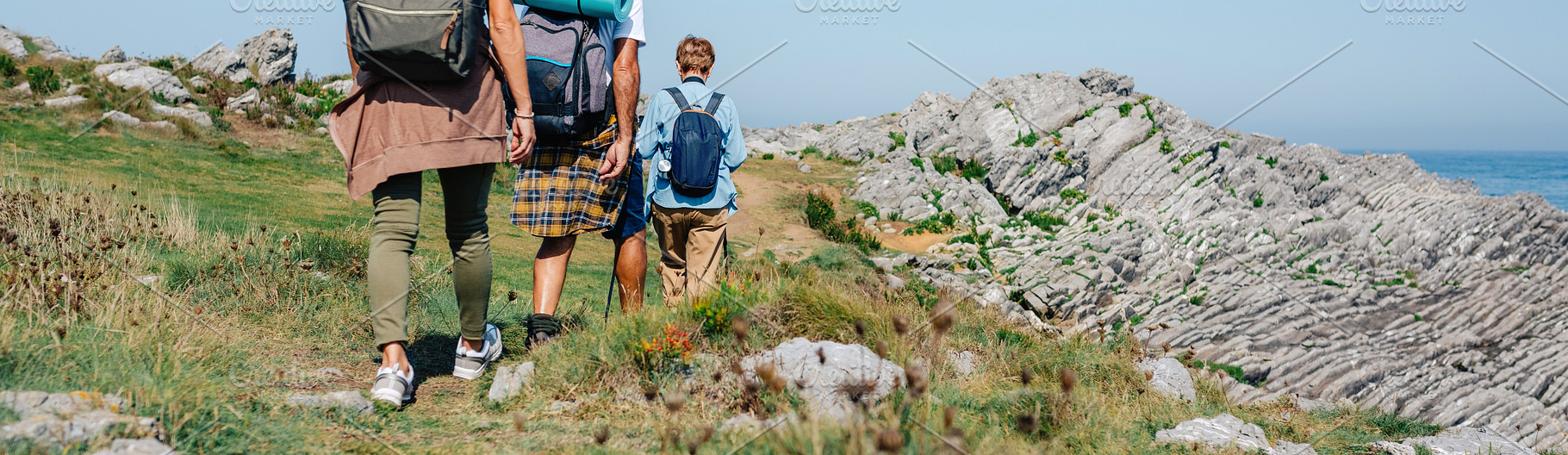 Senior couple with their adult daughter on their backs trekking, a Holiday Photo by davidpereiras