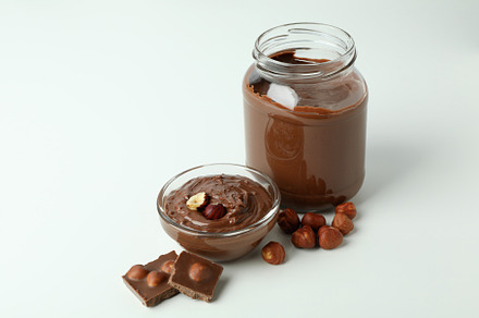 Concept of delicious food with chocolate paste on white backgrou, a Food & Drink Photo by AtlasStudio