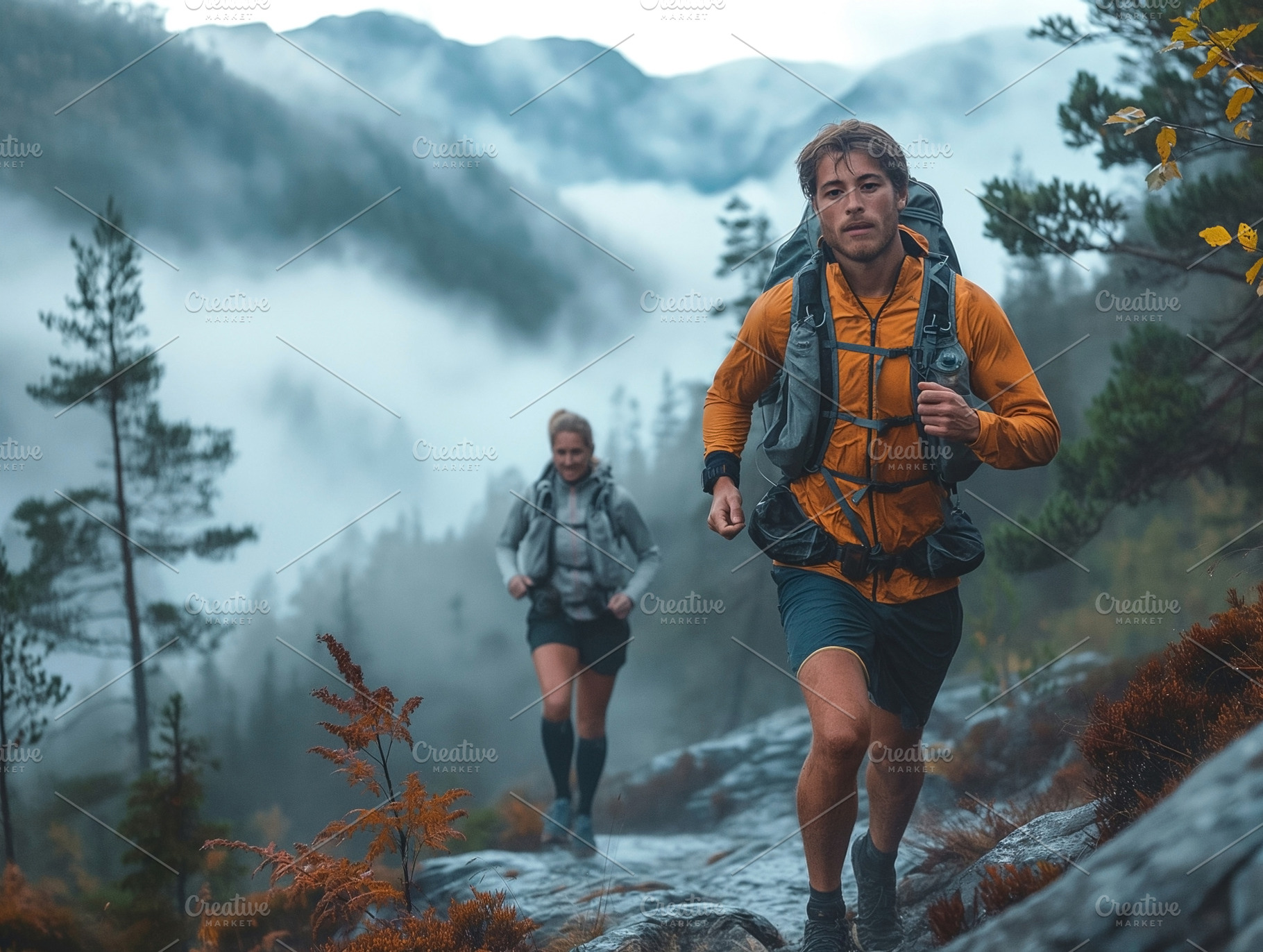 A young Caucasian male and female hiking energetically through a foggy mountain, a Person Photo by ImageMir