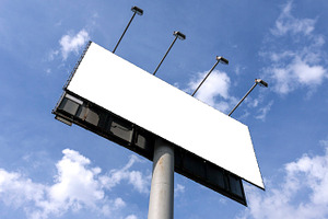 Outdoor billboard against blue sky, an Industrial Photo by BOOCYS