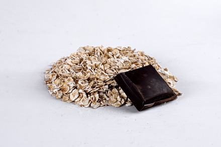 Raw oatmeal on an isolated on white background. Side view of raw dry rolled oat, a Background Photo by nafood