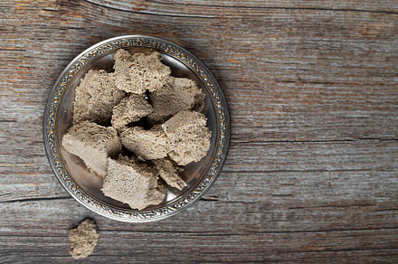 Vegetable-based halva sweet prepared from seeds on wooden background, top view, a Food & Drink Photo by zakiroff