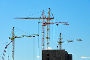 Cranes are lifting materials at a, an Industrial Photo by darksoul72