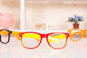 Sunglasses on table containing glasses, sunglasses, and glass