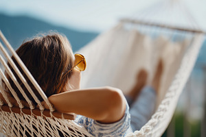 Woman relaxes in a hammock, a Person Photo by MistyDay