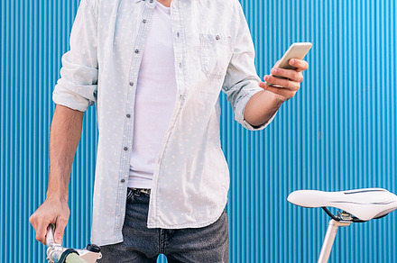Young man with mobile and bicycle featuring mobile, man, and bicycle, a Person Photo by nunezimage