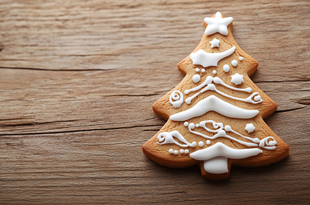Christmas gingerbread fir tree cookie on wooden table, a Holiday Photo by AlyaAnd