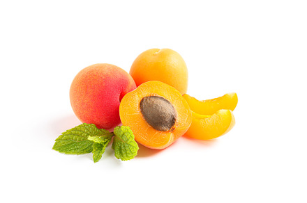 Apricots with mint isolated on white background, a Food & Drink Photo by AtlasStudio