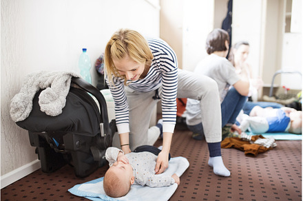 Mother changing diaper after group, a Sports & Recreation Photo by HalfPoint