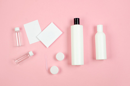 Different cosmetic bottles and container on pink background,, a Health & Medical Photo by vimart