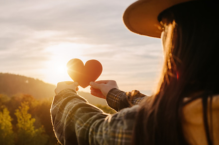 Woman in hat holding red heart, a Beauty & Fashion Photo by Yura_Yarema