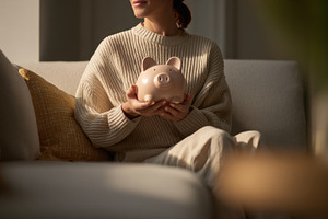 Holding a piggy bank at home, a Photo by Beautiful things