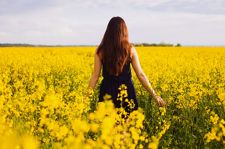 Girl enjoying rapeseed blooming stock photo containing back and blooming, a Beauty & Fashion Photo by Sergey Furtaev